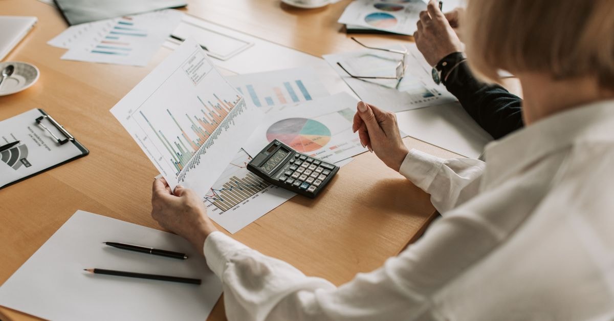 Shopify acquires Tailwind Labs to anchor its open-source CSS stack Business team analyzing financial data and graphs during a meeting to strategize growth.