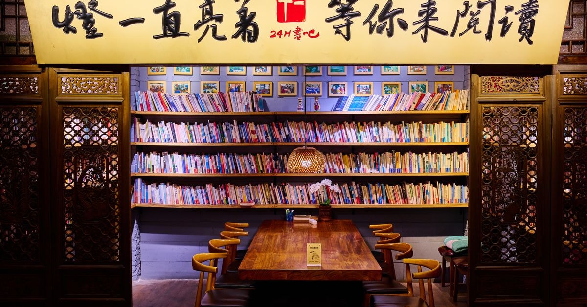 Warm and inviting Asian-style reading nook with wooden furniture and bookshelves.