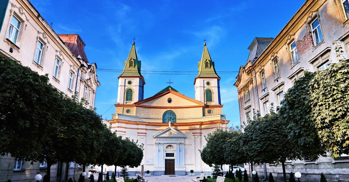 Lviv Travel Guide: Cobblestone Charm in Western Ukraine Stunning view of a historic church between buildings in Lviv, Ukraine.