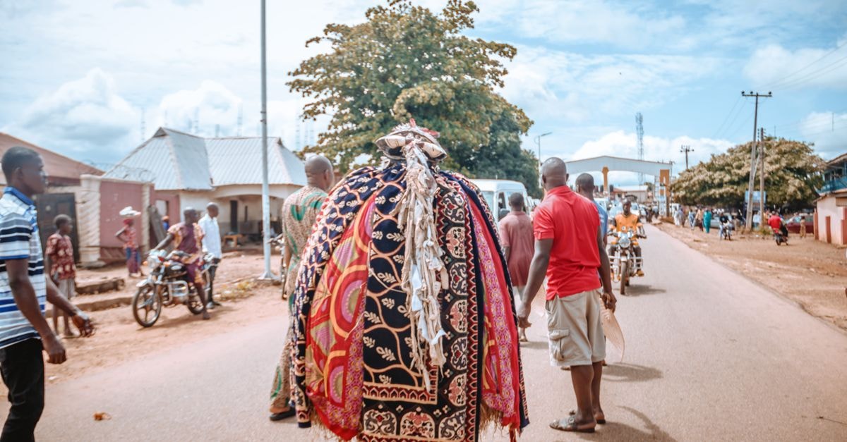 Efon-Alaaye travel guide: a quiet Ekiti town worth slowing down for A vibrant traditional festival procession on city streets showcasing colorful attire and cultural celebration.