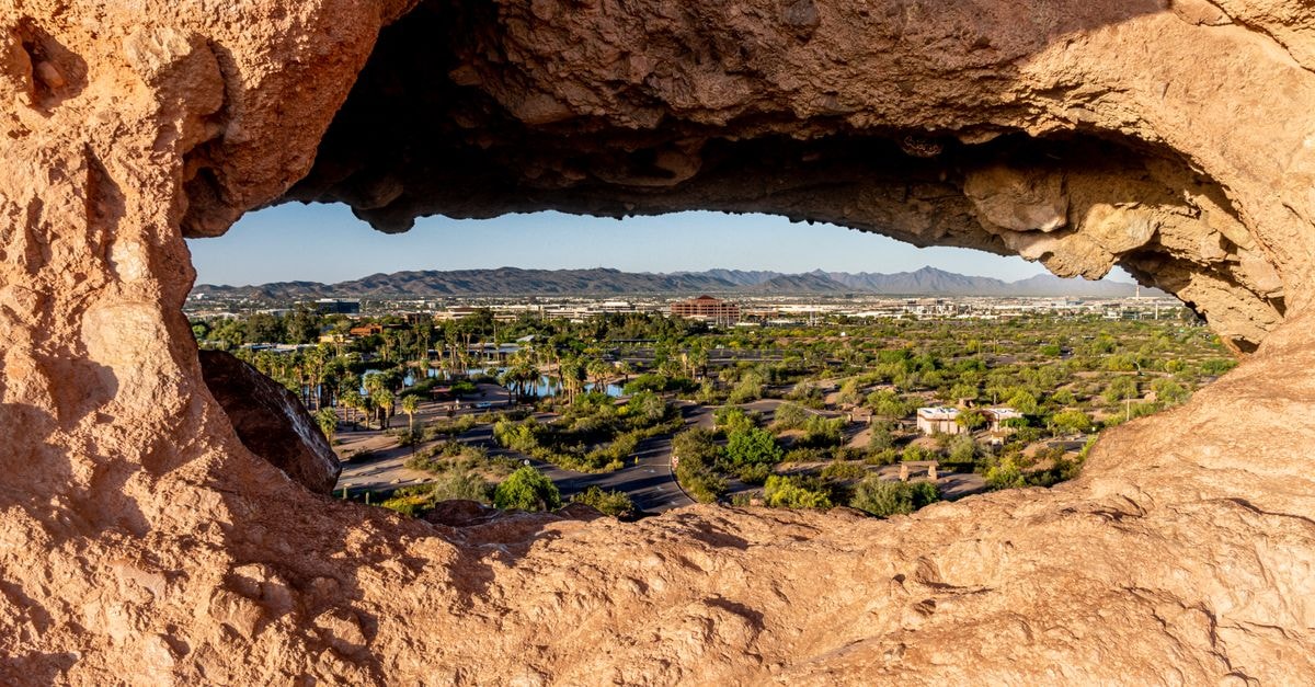 Capture of Phoenix cityscape through a unique rock formation in Papago Park, Arizona.