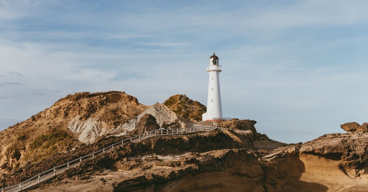 Scenic view of Castlepoint Lighthouse on a sunny day in New Zealand.