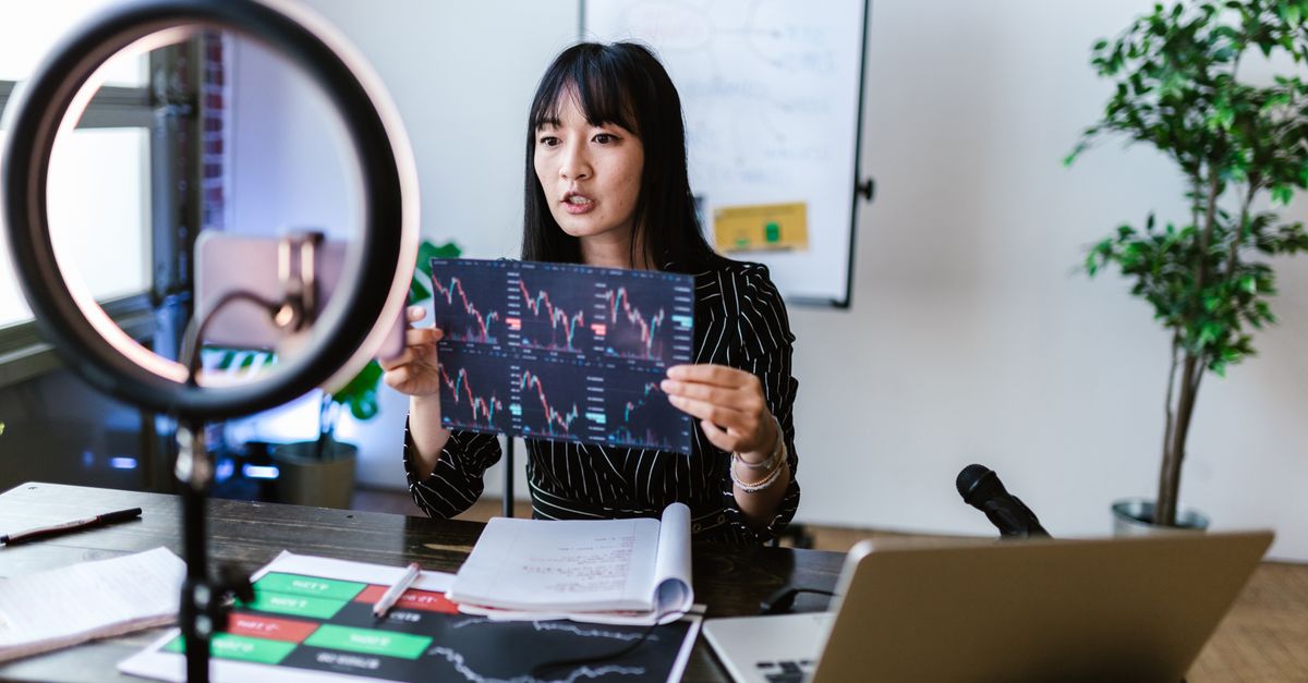 Jennie's 'Less than a Lover' tops YouTube trending worldwide and leads iTunes charts in 27 regions A woman vlogger discusses stock market trends using charts in a home studio.