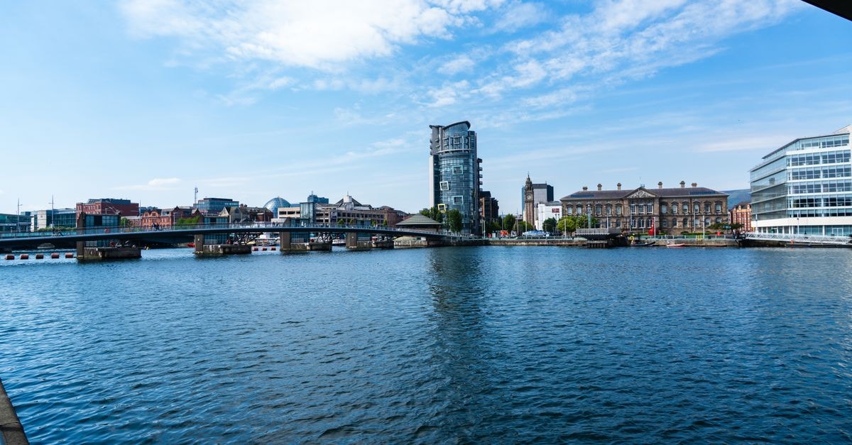 View of the Lagan River with the Belfast skyline, showcasing modern and historic architecture.
