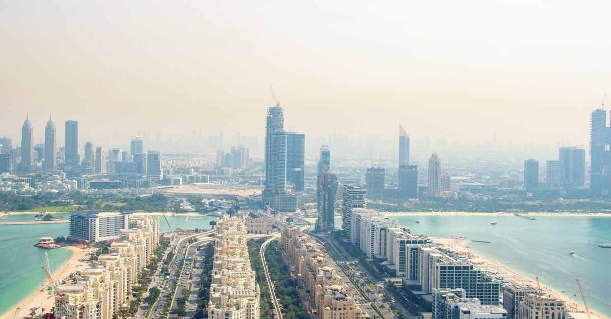 Meydan Hotel in Dubai: Trackside Views at Meydan Racecourse Stunning aerial shot of Dubai's skyline featuring iconic architecture and palm-lined beaches.