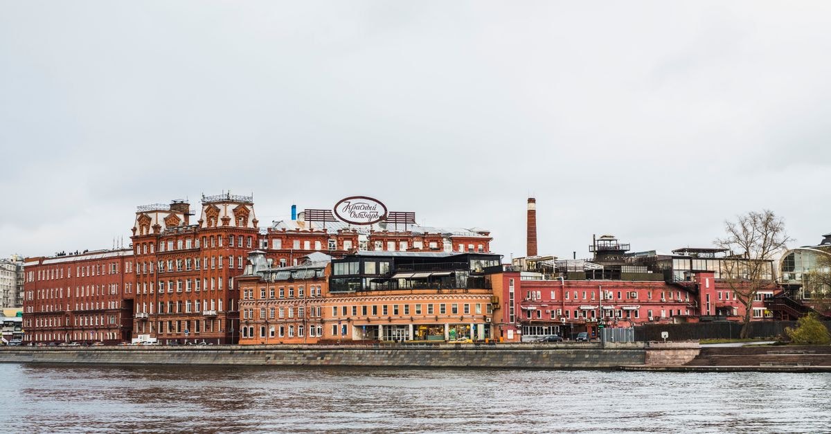 Karaganda Travel Guide: Industrial Heritage and City Soul Scenic view of historic factory building by the Moscow River on an overcast day.