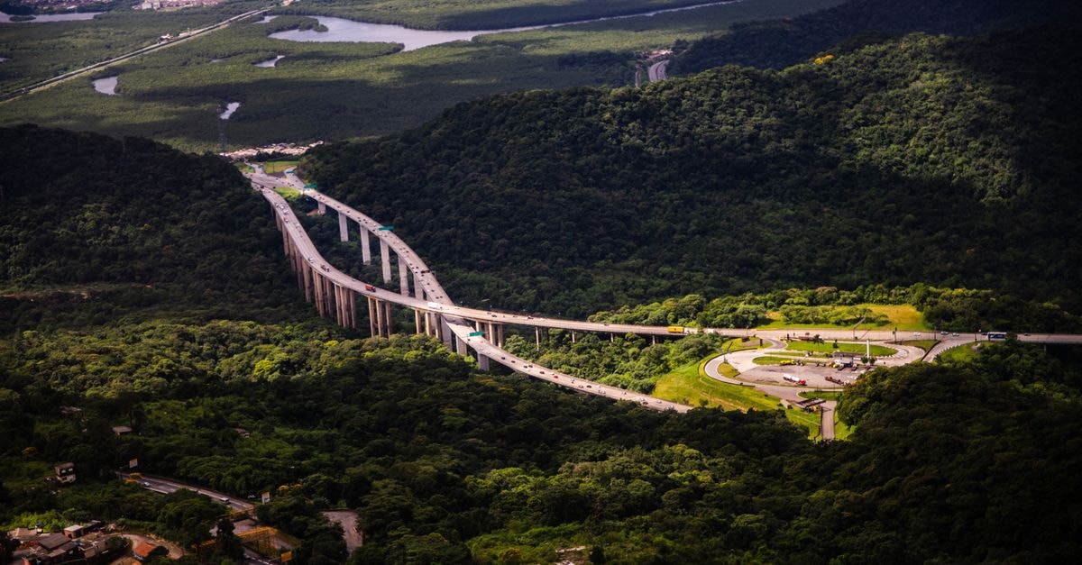 Maracanau Travel Guide: Planning Tips, Costs and Things to Do Breathtaking aerial view of a highway cutting through lush greenery in Santos, São Paulo, Brazil.
