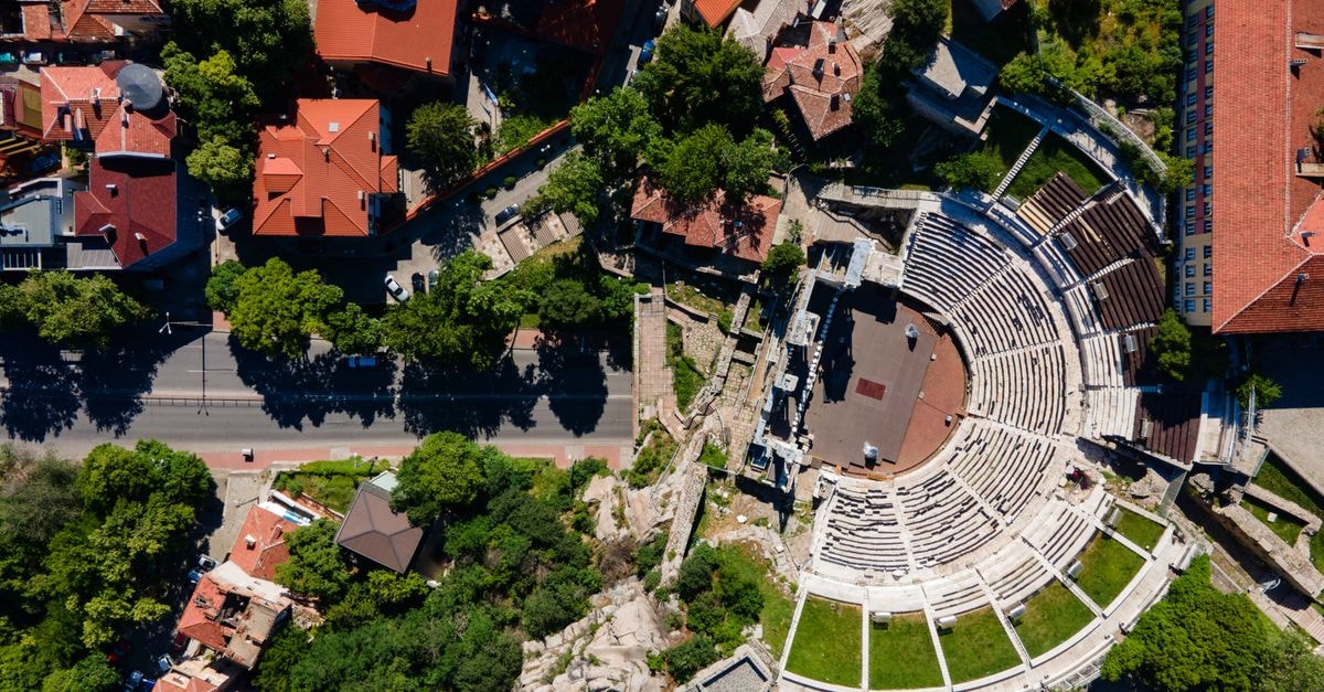 Central Hotel in Veliko Tarnovo: Quiet Street Steps From the Old Town Aerial view of the Ancient Theatre of Philippopolis in Plovdiv, Bulgaria, surrounded by urban architecture.
