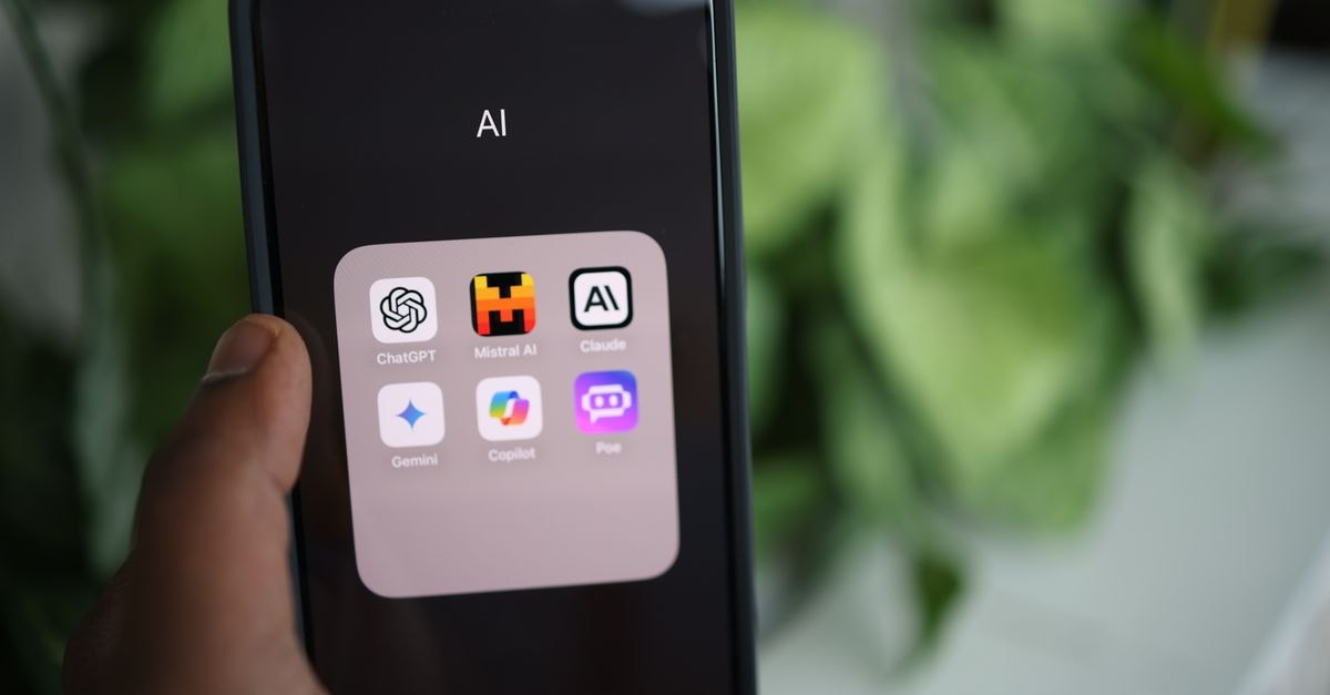 Shopify Embraces Meta's Muse AI Agent While Amazon Blocks It Close-up of a hand holding a smartphone with AI applications on screen.