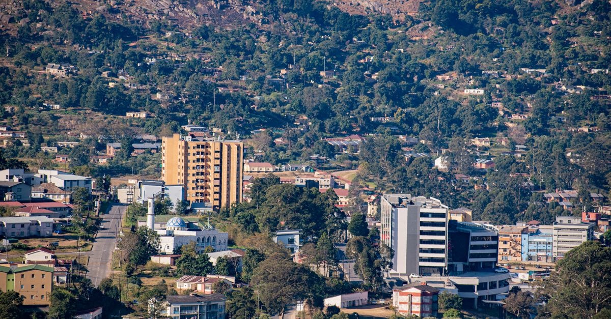 A scenic aerial view showcasing the urban landscape of Manzini, Eswatini with a mix of buildings and greenery.