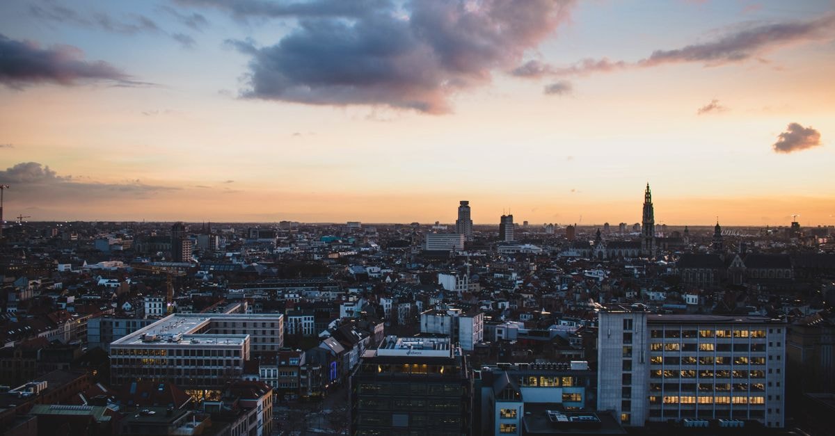 Étoile Blanche in Tissemsilt: a central stay near Rue du 1 Novembre A stunning aerial view of Antwerp, Belgium, cityscape at dusk with vibrant sky colors.
