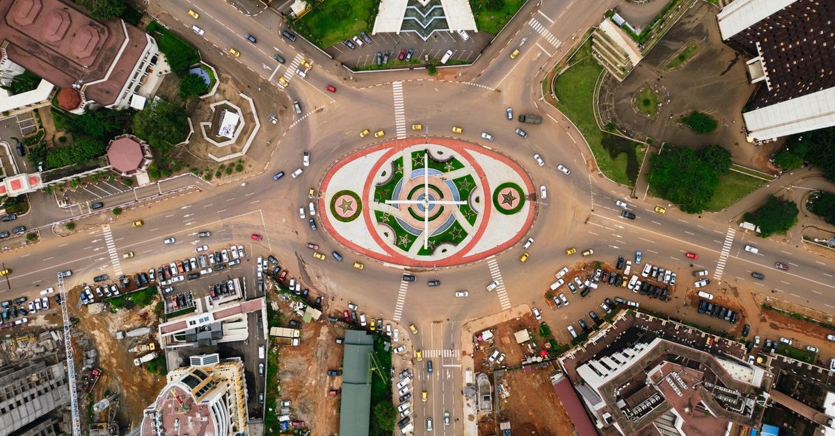 Peemos Hotel Warri, Warri — A Quiet Stay Opposite the Governor’s Lodge Stunning aerial view of the bustling traffic circle in Yaoundé, showcasing urban architecture and city life.