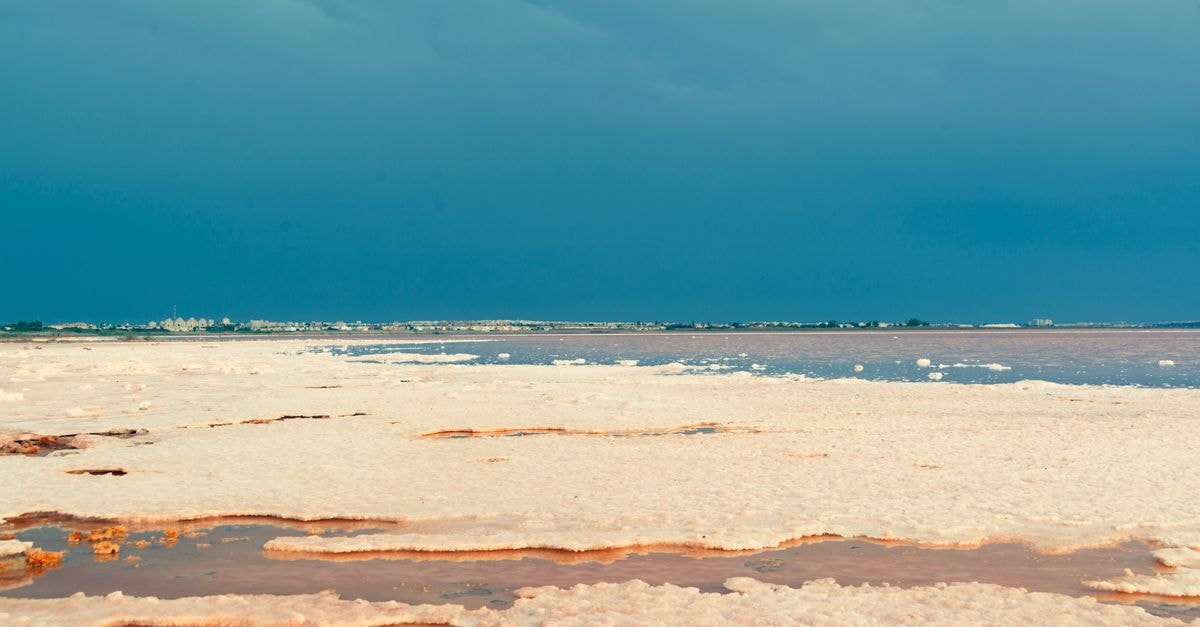 Breathtaking view of Torrevieja's salt flats under a dramatic sky.
