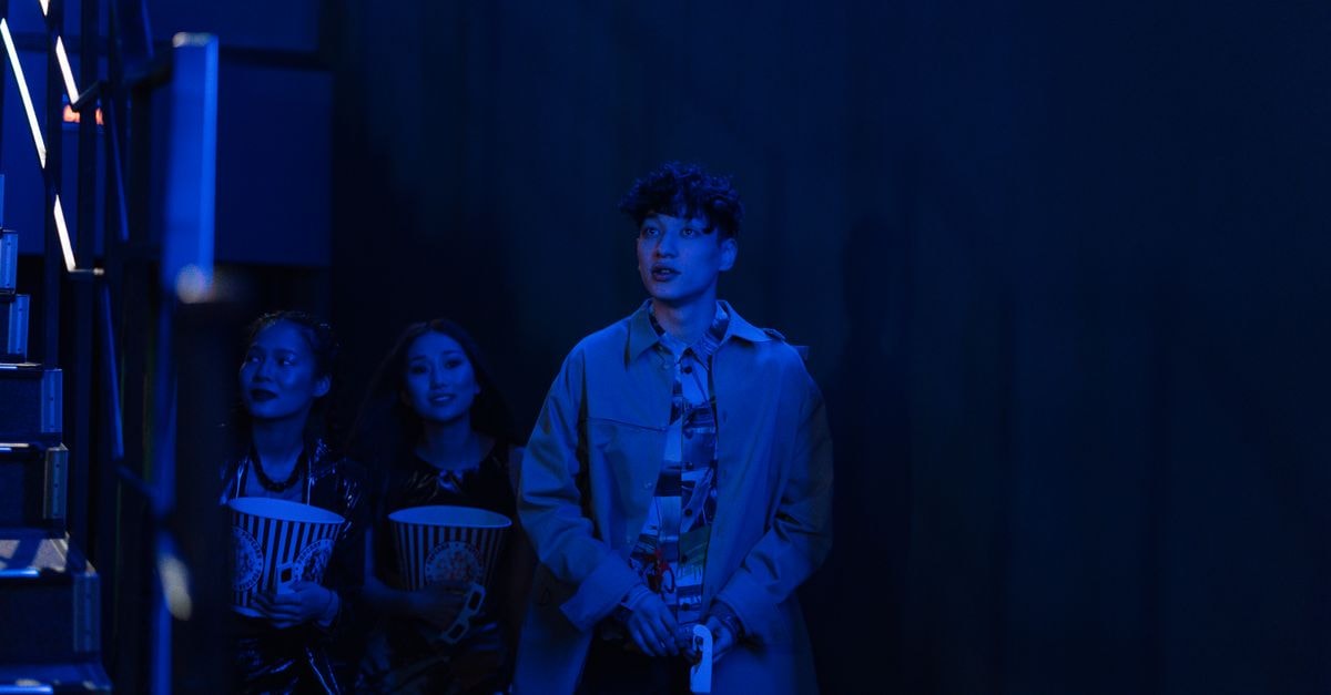 Bowen Yang to make Broadway debut in 'Oh, Mary!' this fall Three friends attending a movie night at a cinema, holding popcorn in the dark theater.