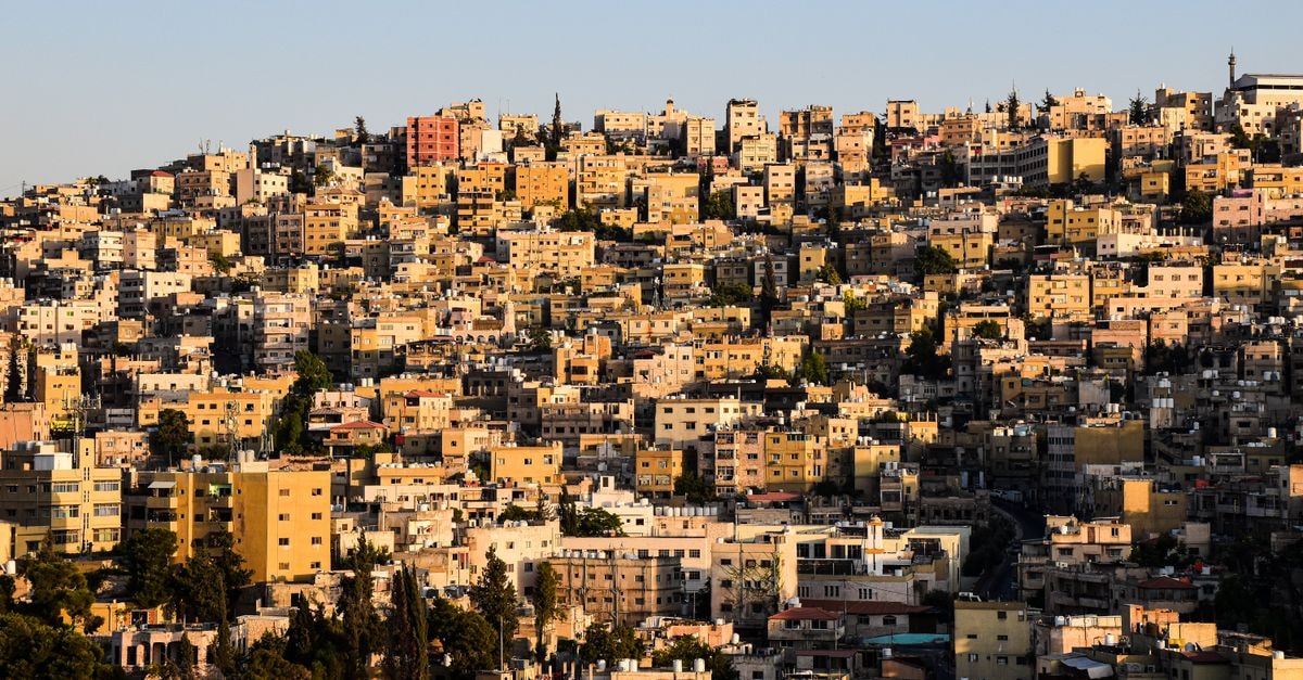 Jawabreh Hotel & Suites, Zarqa: A 5-Minute Walk to City Centre Aerial view of Amman's dense urban landscape with houses tightly packed together, showcasing city life.