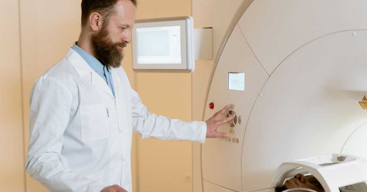 Cleveland Clinic and IBM Detail Quantum Machine Learning Model for Cancer Neoantigen Prediction A doctor operates an MRI machine as a patient undergoes a scan in a medical facility.