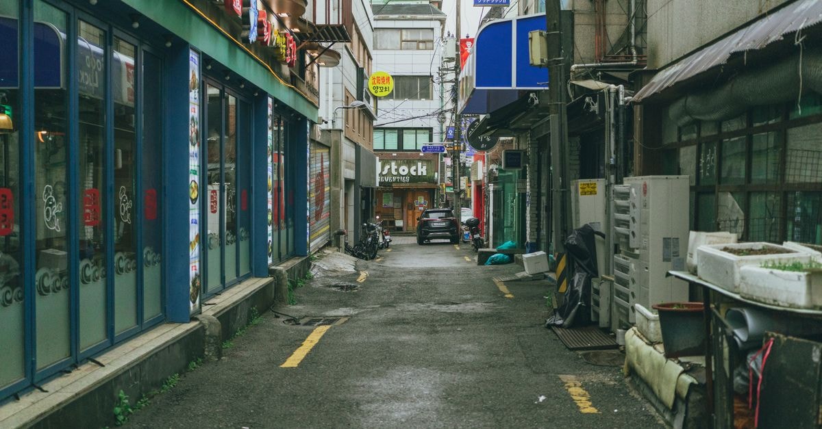 Gwangju Travel Guide: Getting Around, Sights, and Local Food Explore a typical alleyway in Seoul, South Korea, showcasing local architecture and city life.