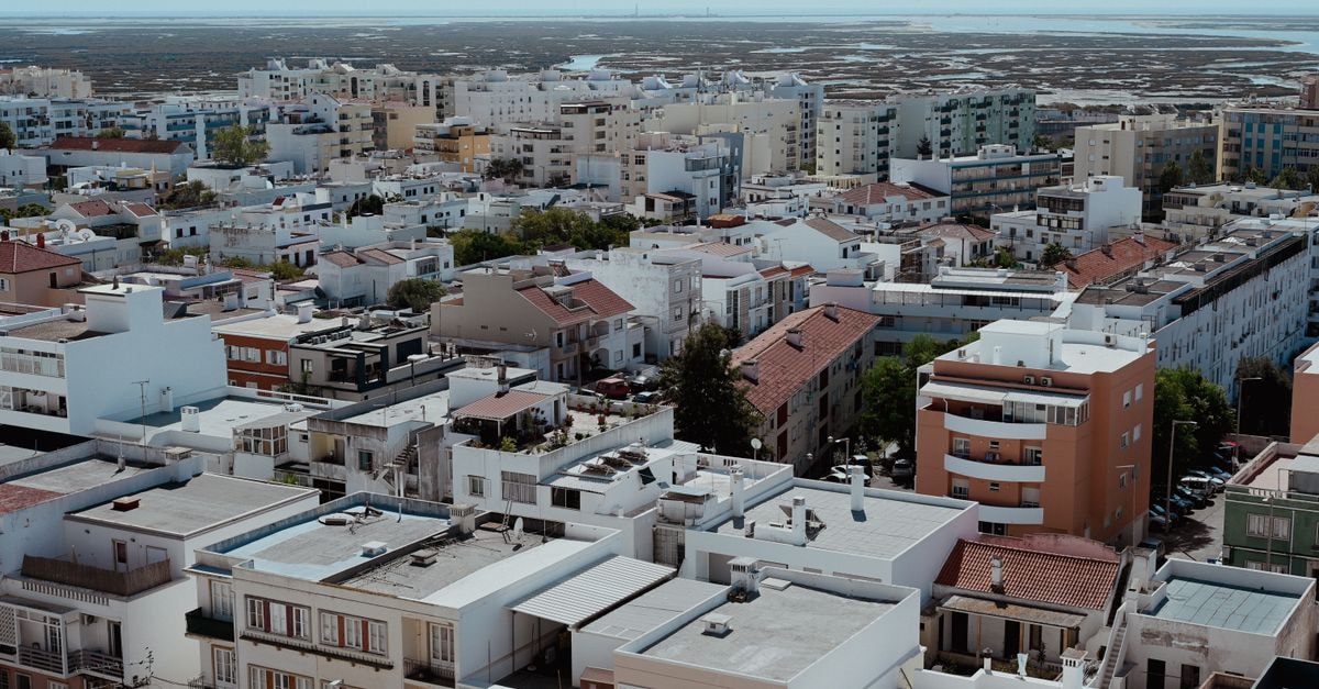 Aqua Ria Boutique Hotel in Faro: A Stylish Stay on Rua de Santo António Aerial cityscape of Faro, Portugal showcasing vibrant architecture and urban planning from above.