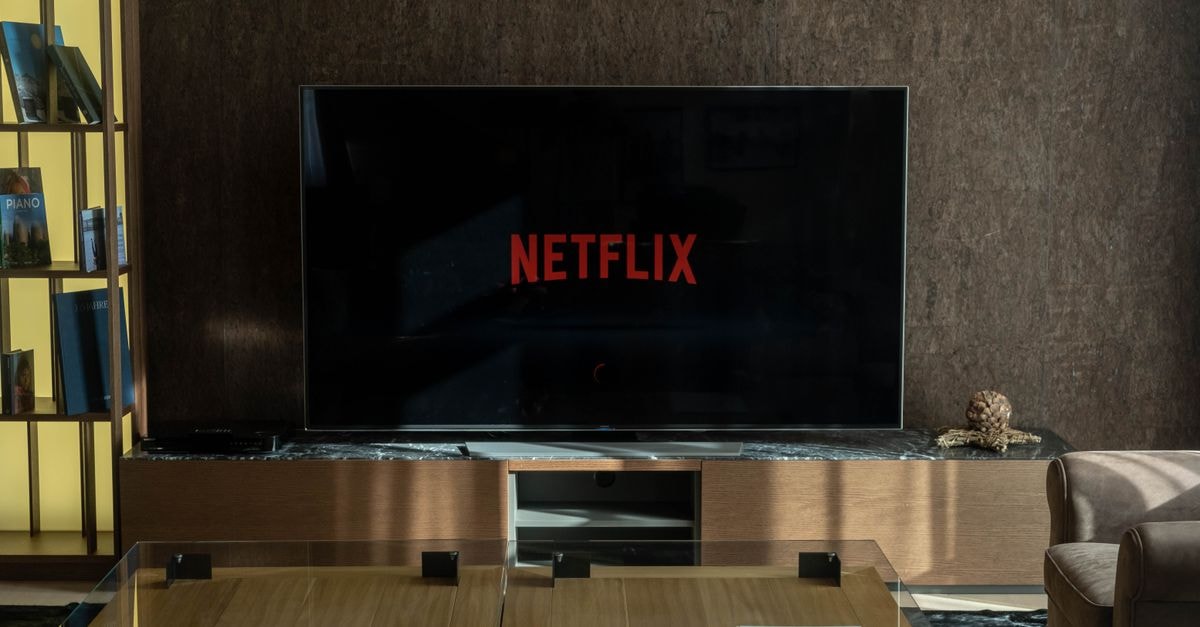 Cozy living room featuring a large TV displaying Netflix, perfect for entertainment.