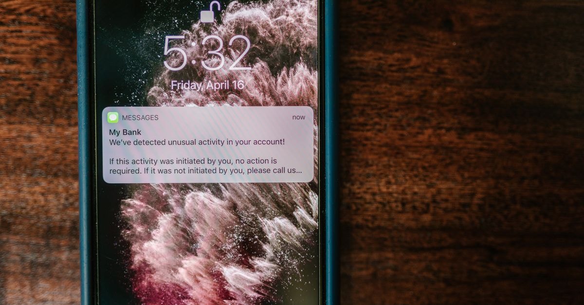 HDFC Bank Securities Class Action: Investors Reminded of October 13 Lead Plaintiff Deadline Close-up of a smartphone displaying a bank alert notification on a wooden table.