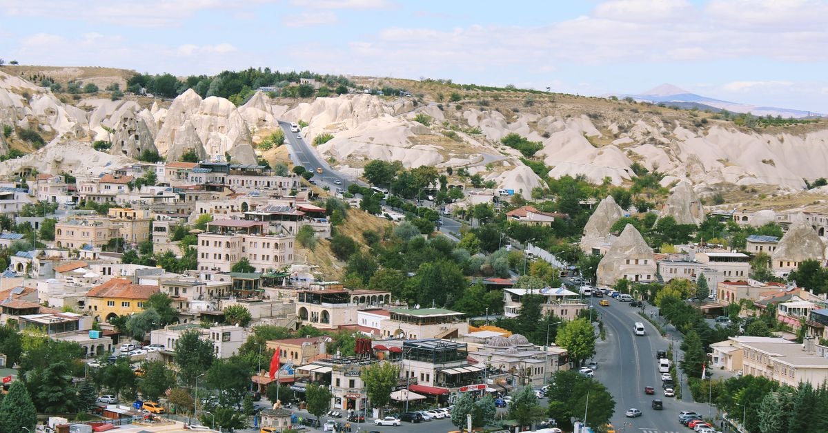 Cappadocia Cave Suites Hotel in Göreme: Sleep Inside Ancient Rock Stunning aerial view of Cappadocia's unique rock formations and town.
