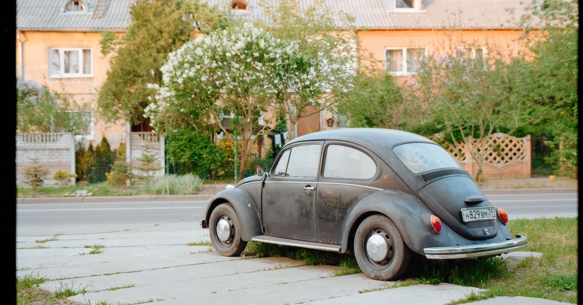 A classic black vintage car parked on a quiet residential street in Kaliningrad, Russia.