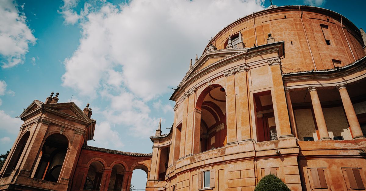 Stunning view of a historic architectural structure with dramatic clouds and vibrant blue sky.