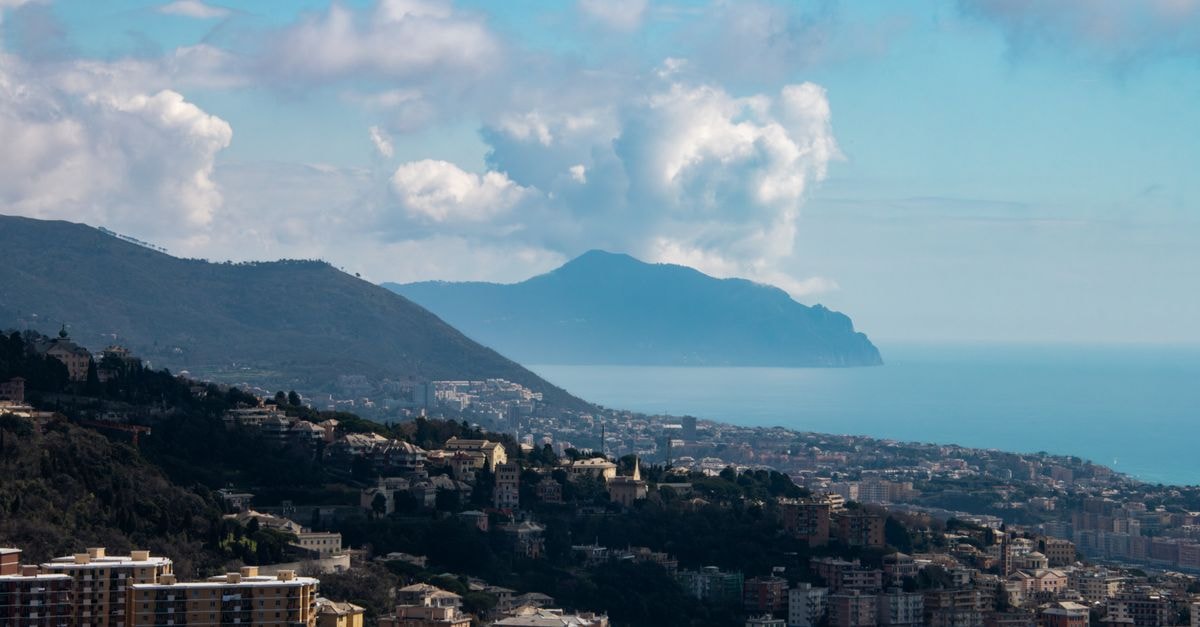 A breathtaking view of Genoa's coastline with mountains and the Mediterranean Sea.
