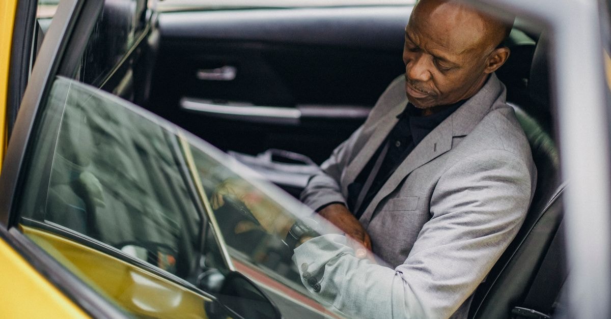 Shaboozey and K. Michelle headline a busy late-July 2026 country release cycle Side view punctual adult African American businessman in formal clothing sitting in taxi car and checking time on wristwatch