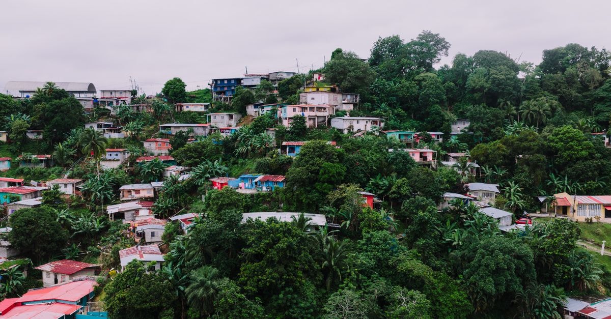 Cabinda travel guide: rainforest coast, local flavors Aerial view of vibrant hillside homes surrounded by lush greenery in Panama City, Panama.