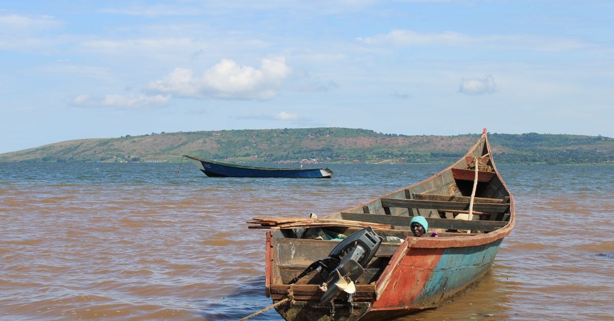 Slow mornings on Lake Victoria: a Bukoba travel guide Rustic fishing boat moored on Lake Victoria in Jinja, Uganda, under a clear sky.
