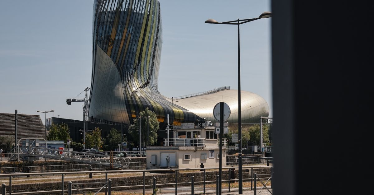 Modern architecture of La Cité du Vin in Bordeaux, France on a sunny day.