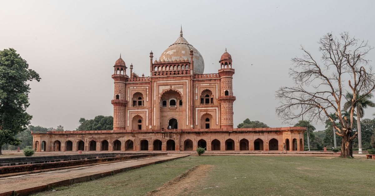 New Delhi Travel Guide: Planning Tips, Costs and Things to Do Scenic view of Safdarjung Tomb with classic Mughal architecture, captured at sunset in New Delhi, India.