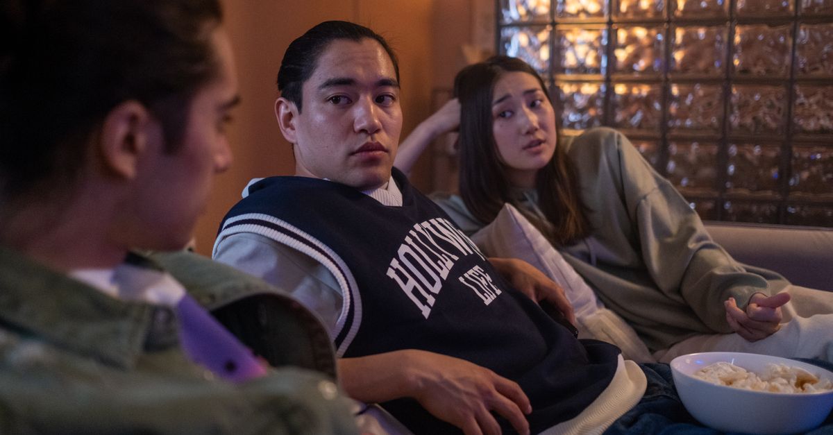 Apple TV+'s 'Lucky' Tops Canadian Trending Rankings for July 24 Weekend Three friends enjoying a relaxed movie night at home with popcorn and cozy atmosphere.