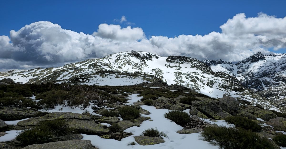 Visiting Makeni: A Slow Travel Guide to Northern Sierra Leone Stunning view of snow-covered peaks and dramatic clouds in Castilla y León, Spain.