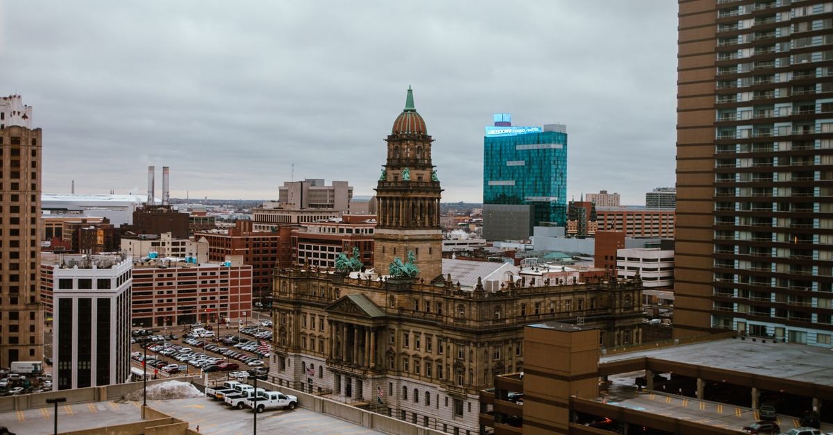 Visiting Lansing, Michigan: A Quiet Capital City Travel Guide Aerial view of Detroit city showcasing historic and modern buildings under a cloudy sky.