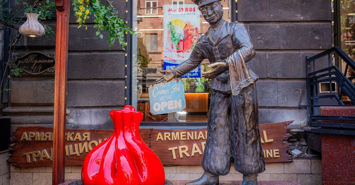 Belgorod Travel Guide: Heartland Calm and Local Flavors A decorative statue welcoming visitors at the entrance of an Armenian traditional restaurant.