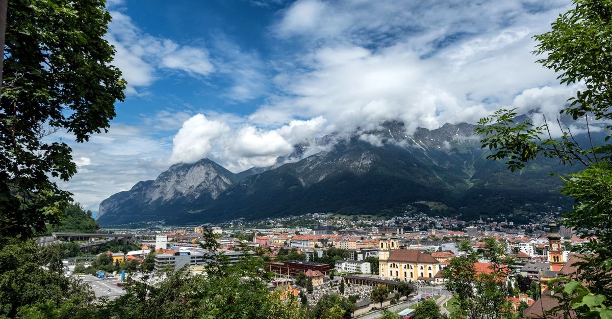 Hotel Drei Könige, Chur — A Family-Run Inn on Reichsgasse Since 1793 Beautiful view of Innsbruck, Austria with mountains and clouds in the background.