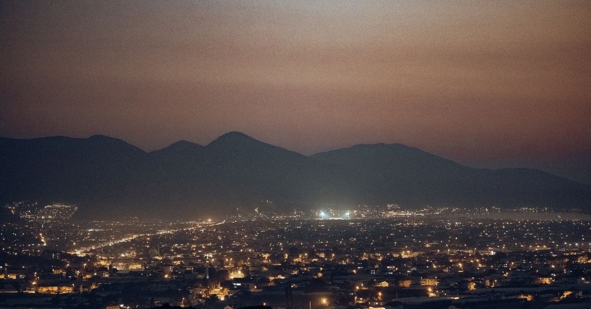 A stunning night view of Fethiye, Türkiye with city lights and mountains in the background.