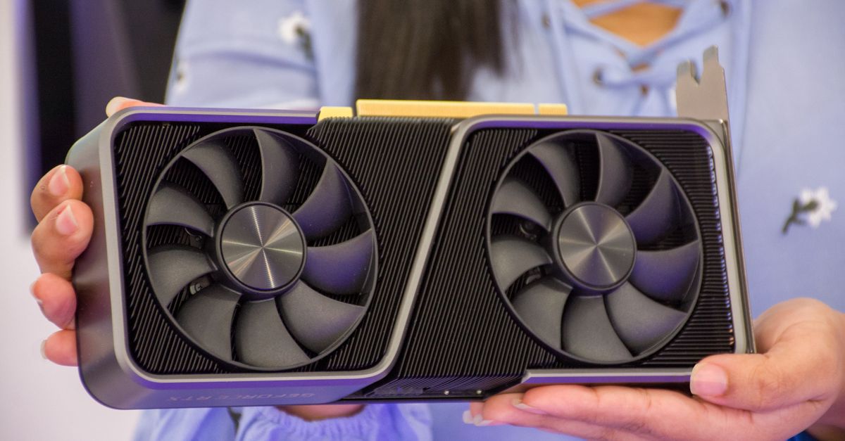 Apple overtakes Nvidia as world's most valuable company Detailed shot of hands holding a modern graphics card indoors.