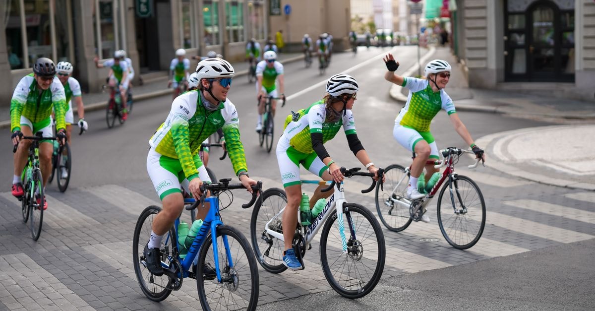 Liberec Travel Guide: Planning Tips, Costs and Things to Do A group of cyclists in vibrant gear biking through the streets of Liberec, showcasing teamwork and outdoor adventure.