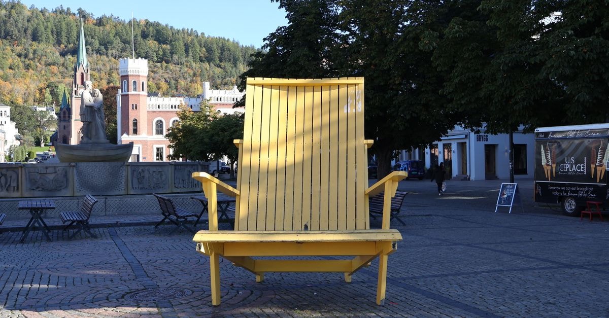 Scandic Ambassadeur Drammen in Drammen: A 2-Minute Walk from the Train Station A large yellow chair is displayed in the city square of Drammen, Norway, surrounded by historic architecture.