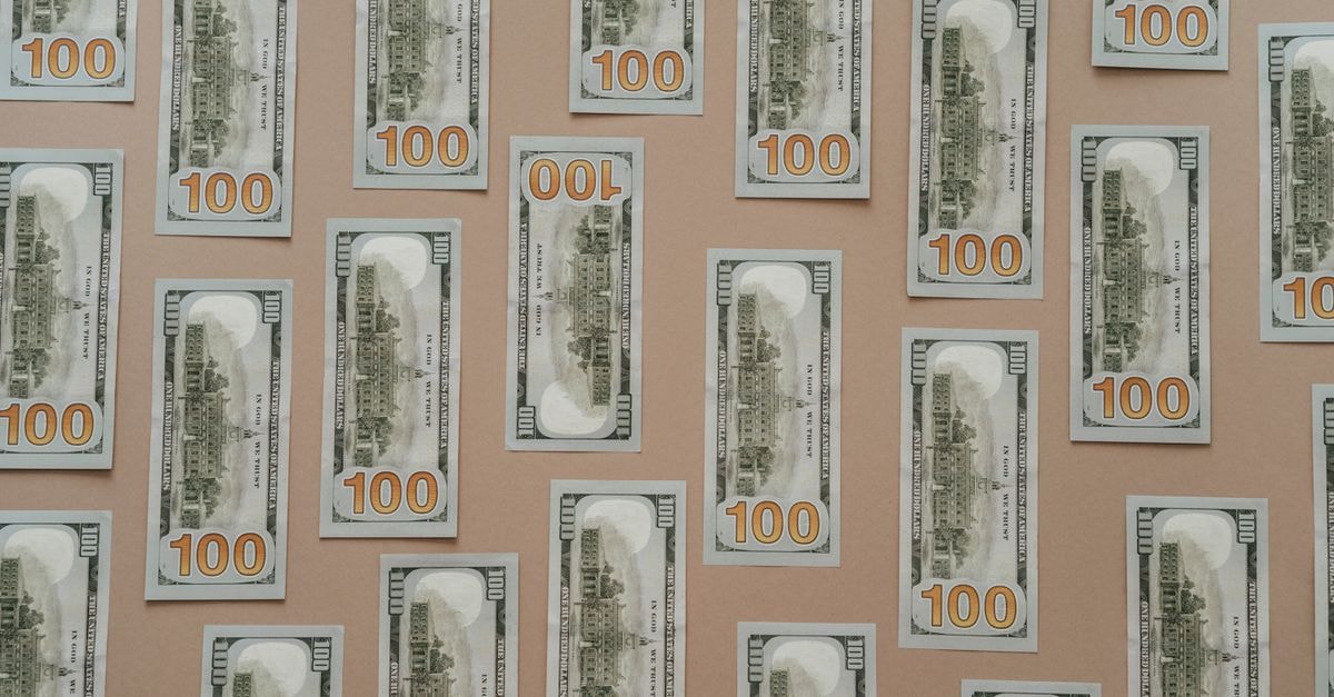 Micron Taiwan unions push for profit-sharing as SK hynix and Samsung bonuses stoke envy Flatlay of hundred dollar bills arranged on a surface representing wealth and finance.