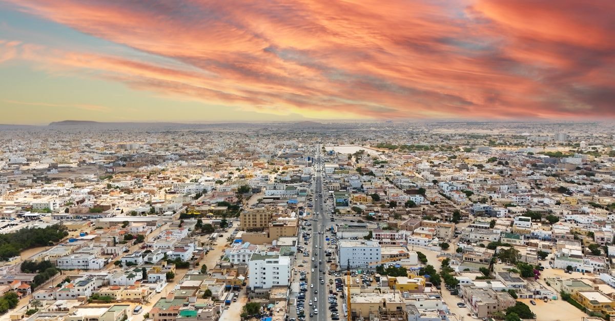 Stunning aerial view of Nouakchott, Mauritania, with vibrant sunset skies and expansive urban landscape.