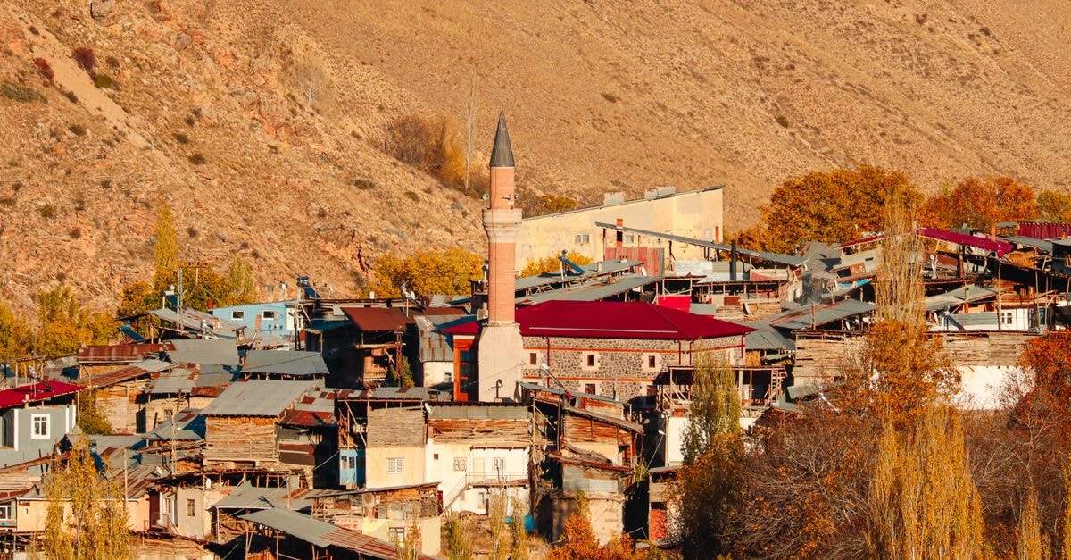 Yozgat Travel Guide: A Quiet Central Anatolian Stop Worth Slowing Down For Charming village with mosque and autumn colors set against a hilly backdrop.