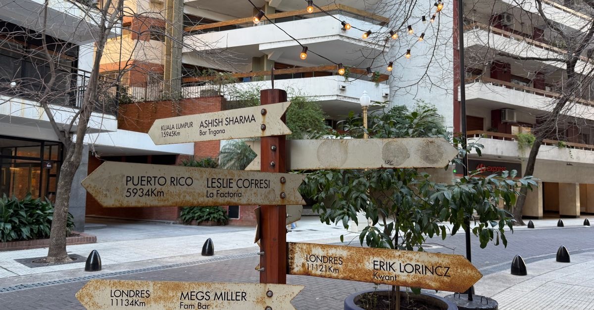 Discover Encarnación: River City Travel Guide Street scene in Buenos Aires featuring diverse directional signs and apartment buildings.