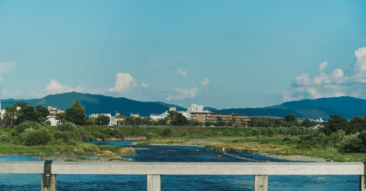 Wayoukan in Ichinomiya: A Roadside Stop Near Inazawa Station Breathtaking view of a river flowing through lush greenery with mountains in the background.