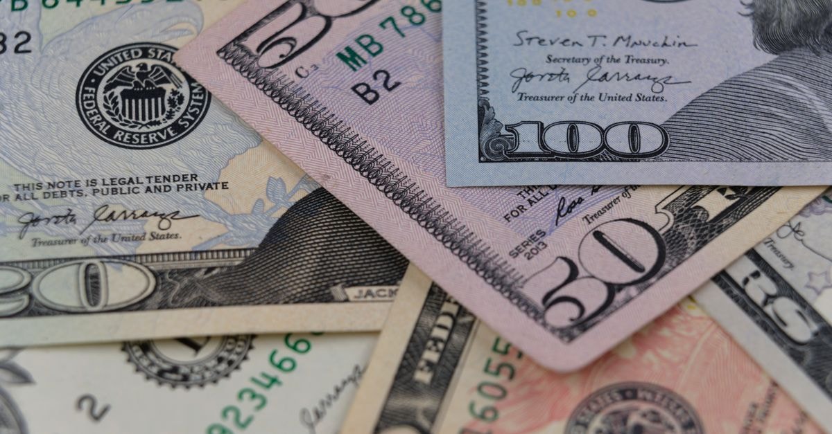 Merck Q3 earnings preview: analysts estimate $17.23 billion in sales Detailed view of US currency, including $50 and $100 bills, symbolizing finance and economy.