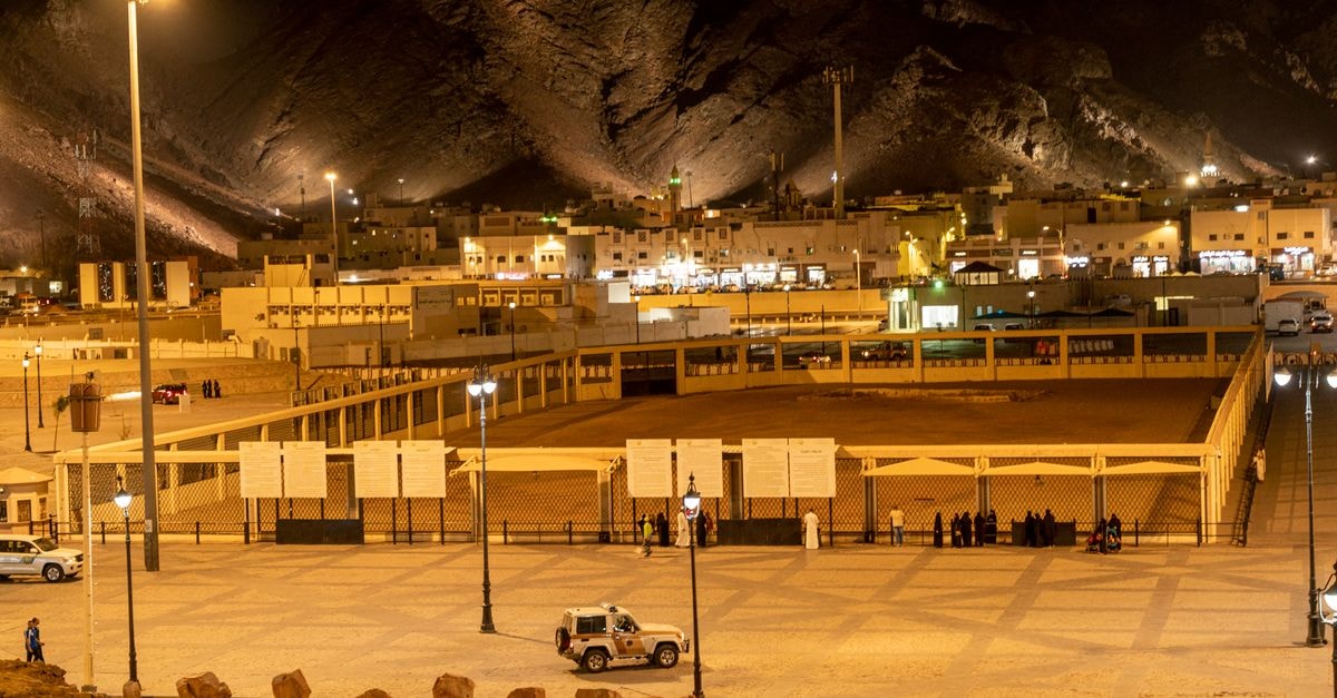 Illuminated Medina landscape with mountains and city lights at night.