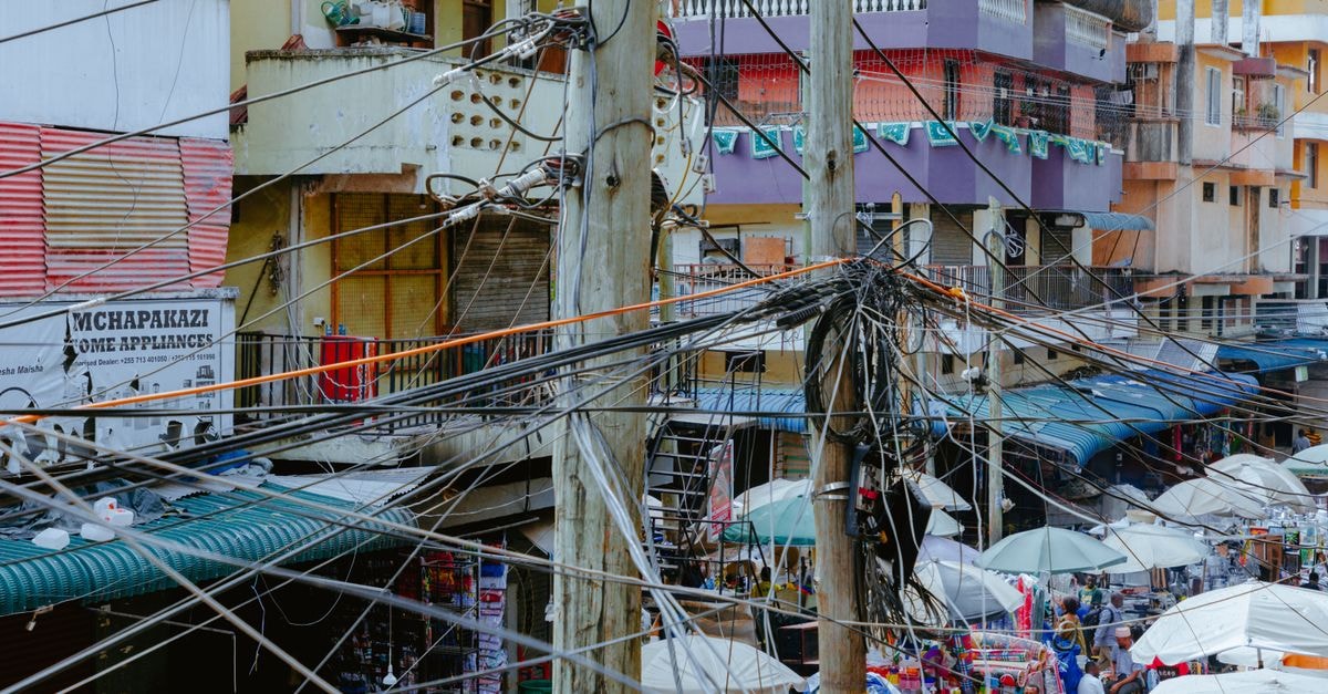 Thika Travel Guide: Markets, Suburbs and Easy Nairobi Connections Vibrant market scene with tangled electrical wires in an urban setting.